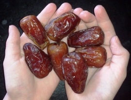 My 8 year old holding dates :) Her fingers are wrinkly like the dates because she just got out of a bubble bath.